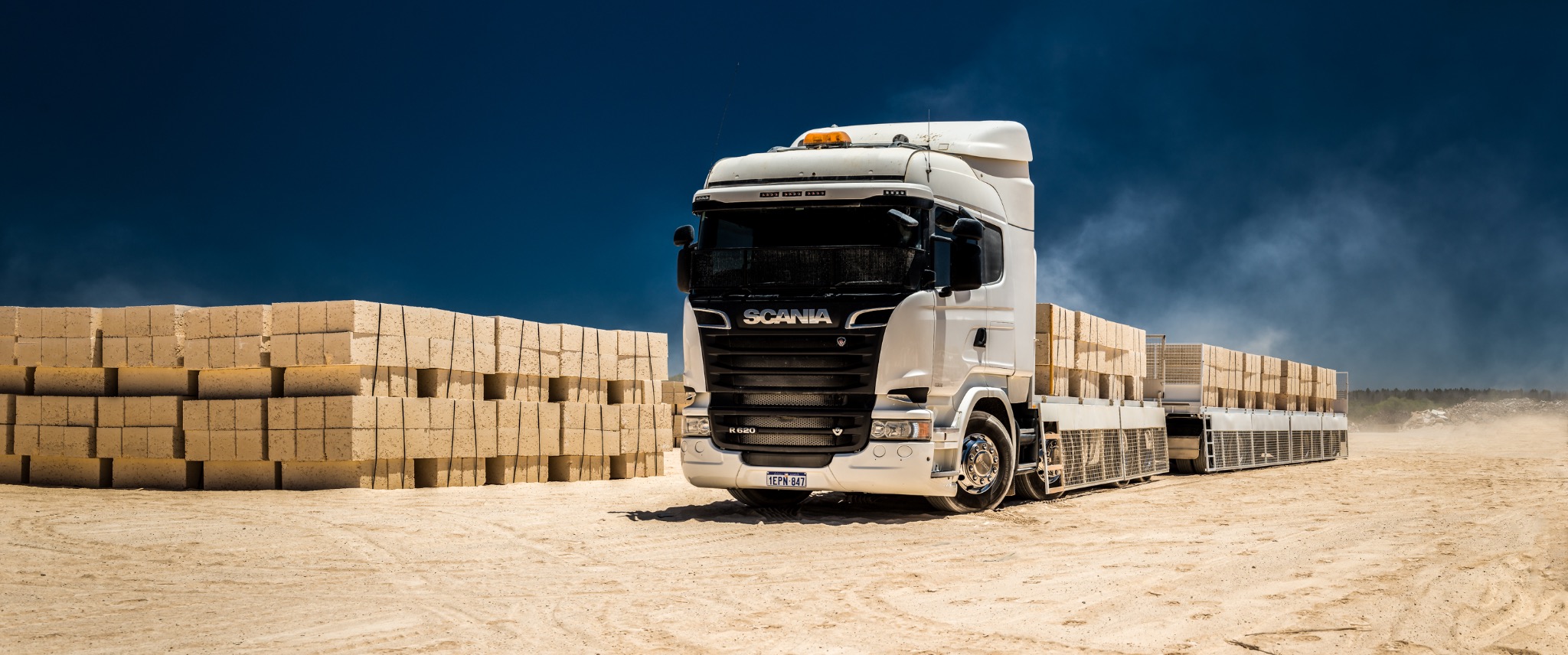 Civex truck beside stacks of construction materials