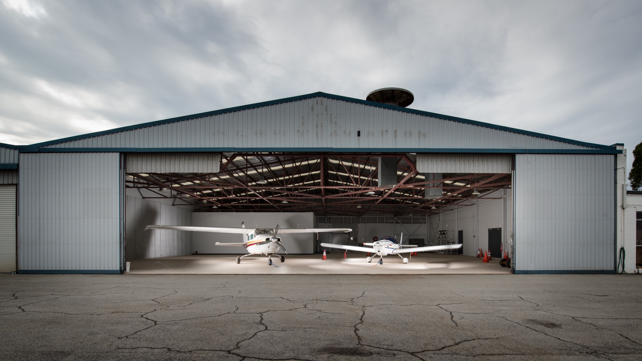 Aircraft inside an open hangar at Jandakot
