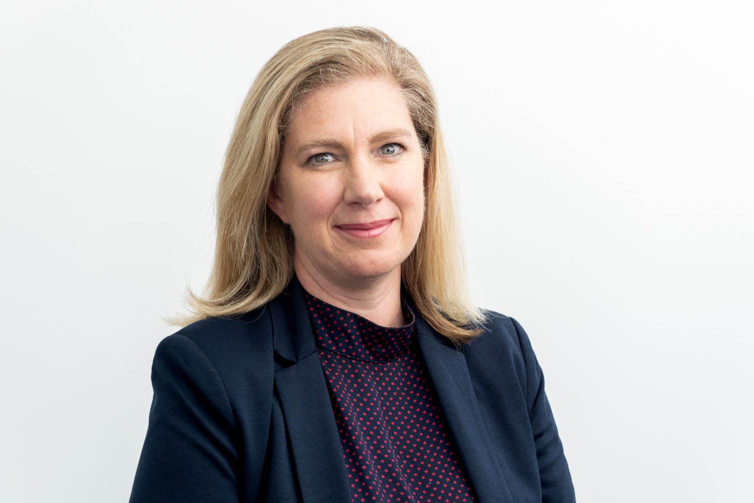 Business headshot against a light background