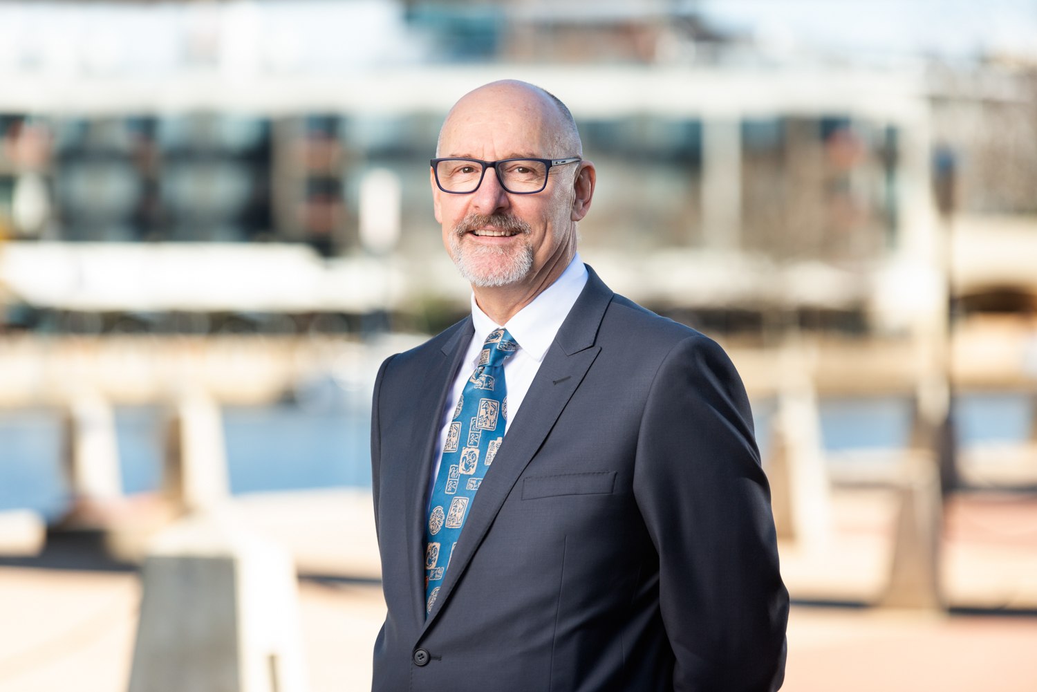 Business portrait in a suit beside the waterfront
