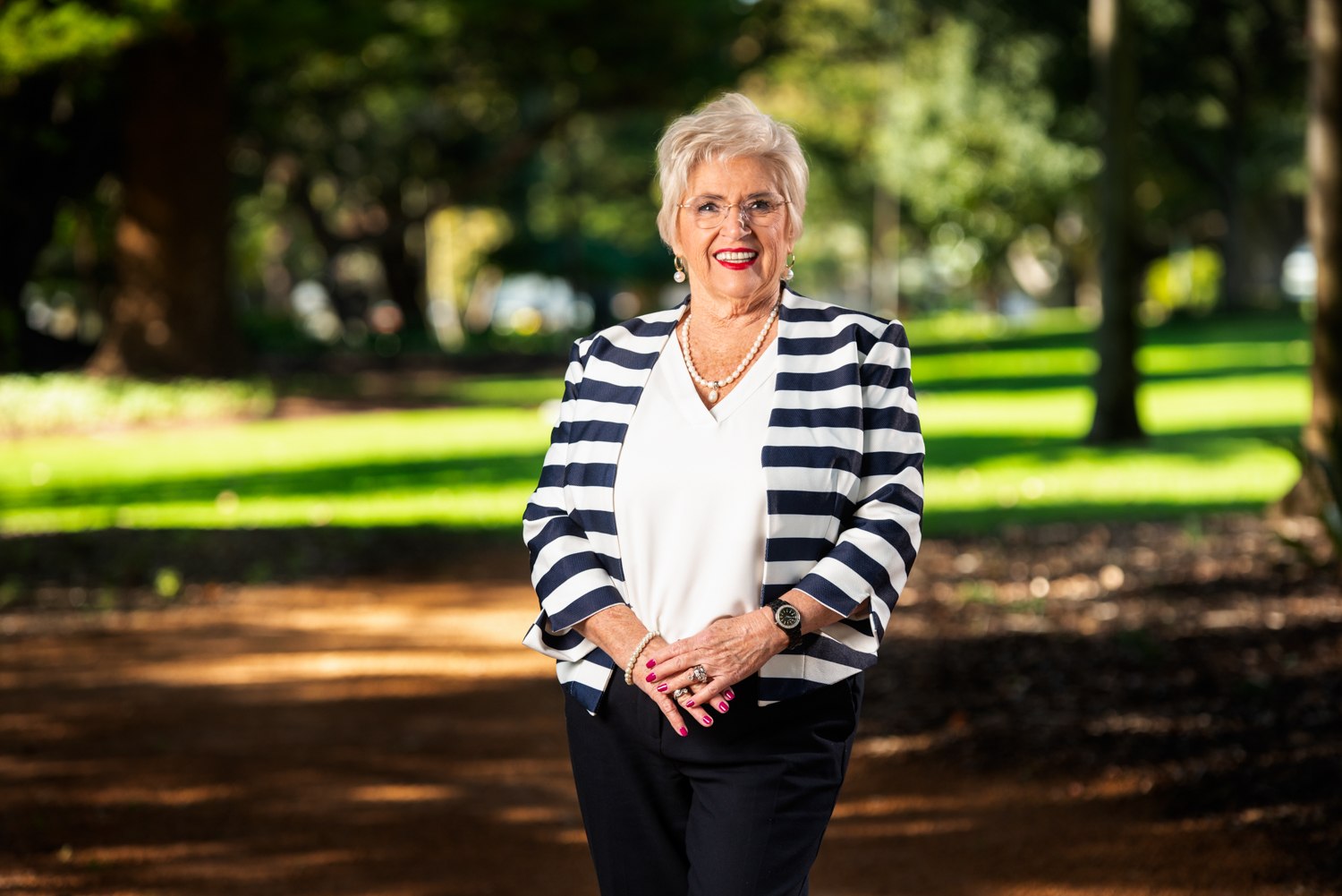 Professional portrait outdoors in a striped jacket