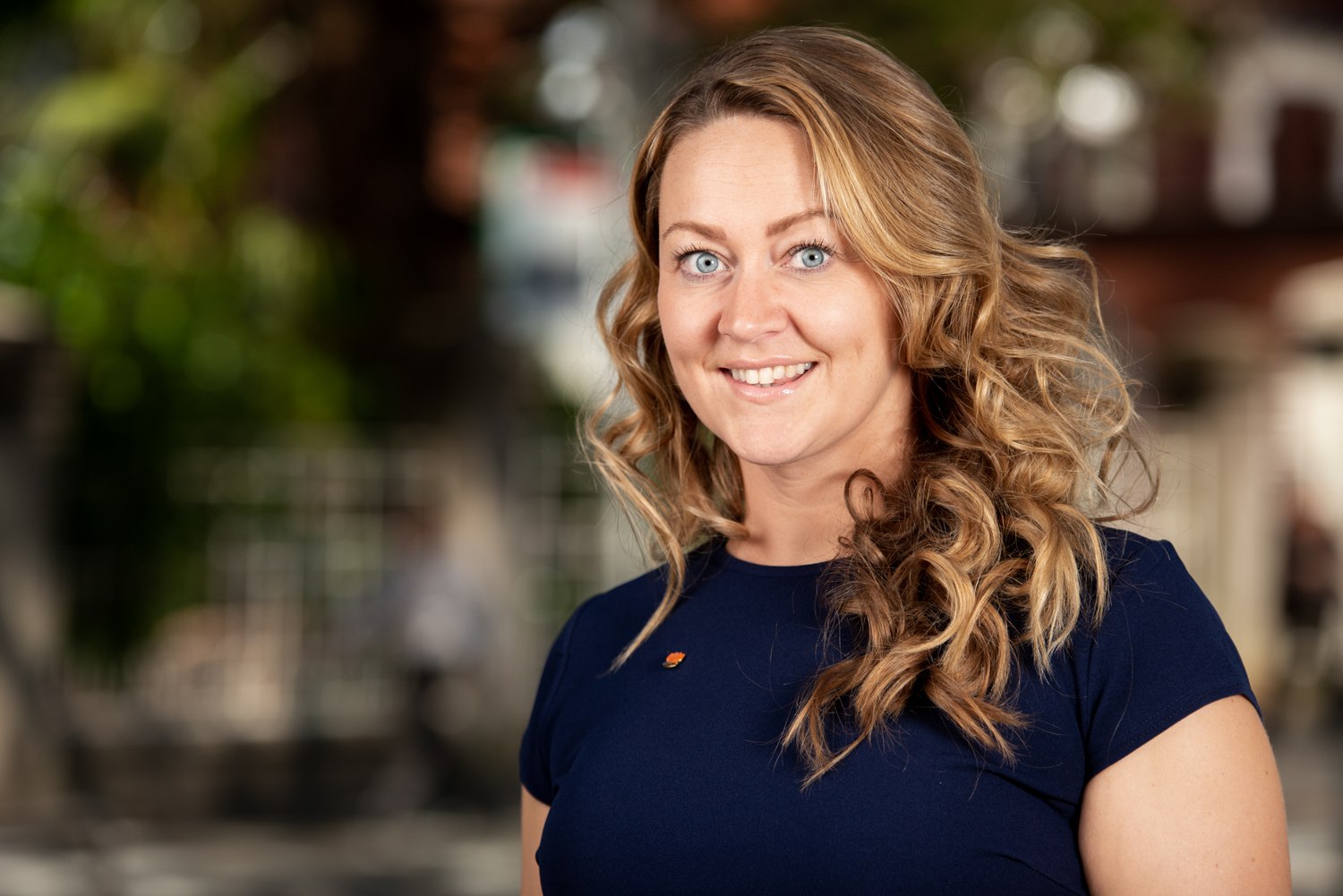 Professional headshot in a garden setting