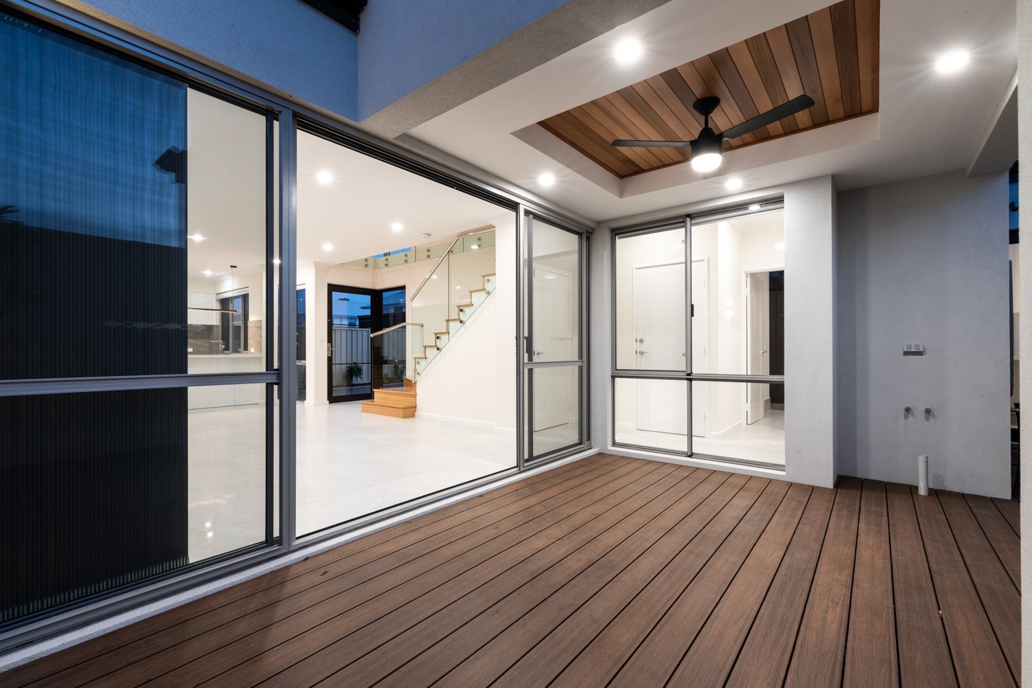 Covered deck with illuminated interiors at twilight in Yokine